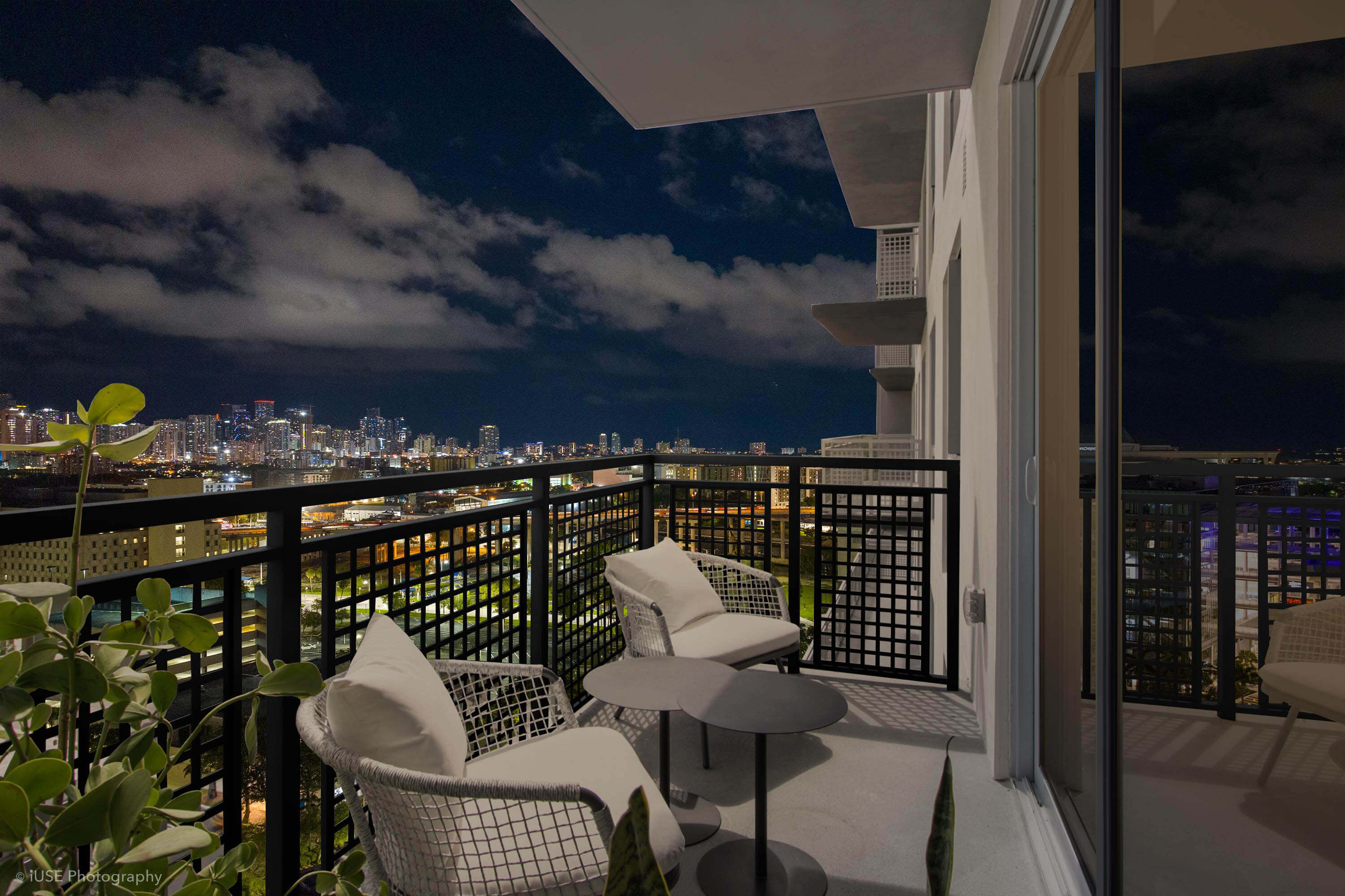 Balcony with skyline view at night from River District 14 luxury apartments