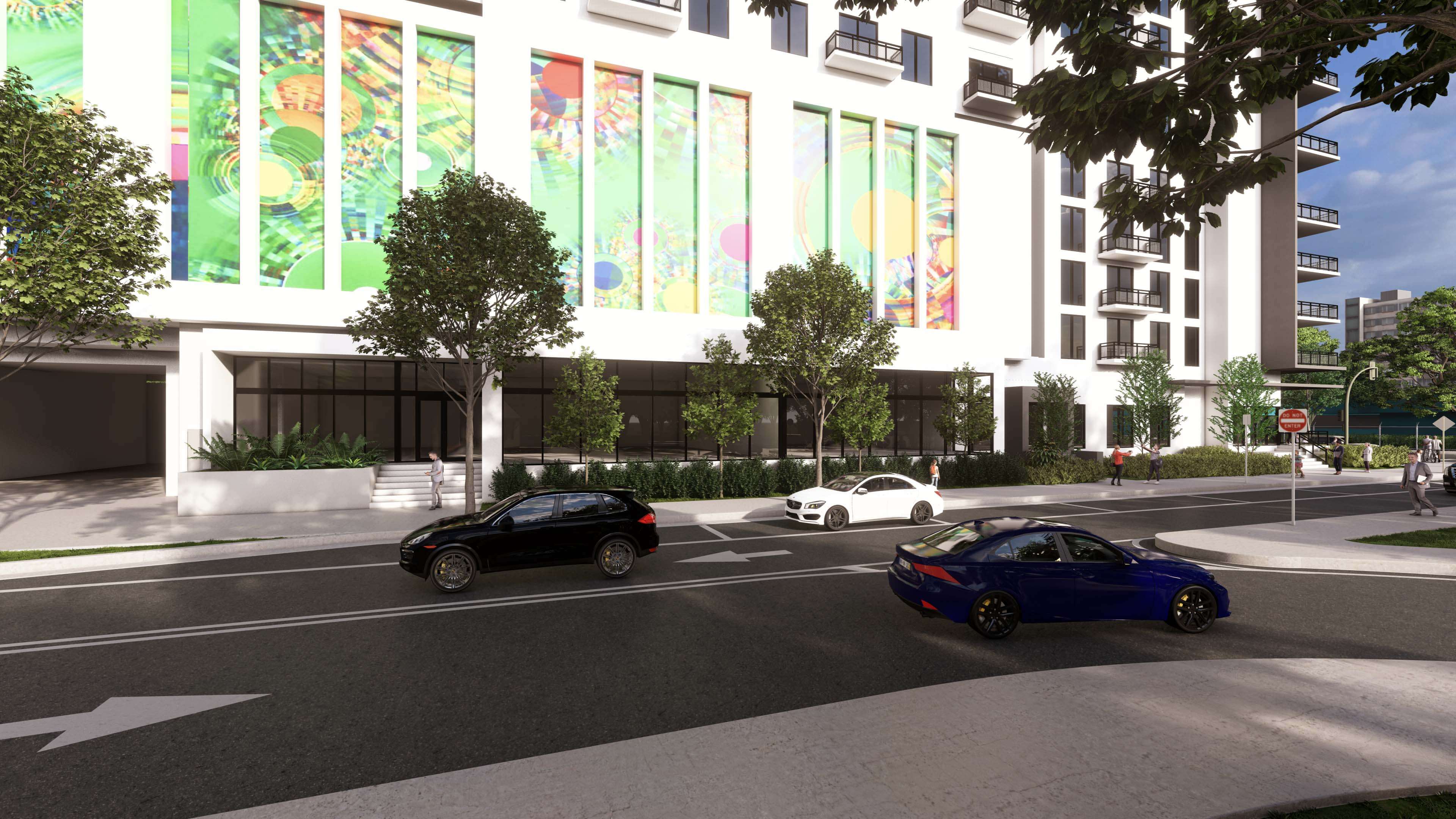 City street activity in front of River District 14 with mural and modern glass base
