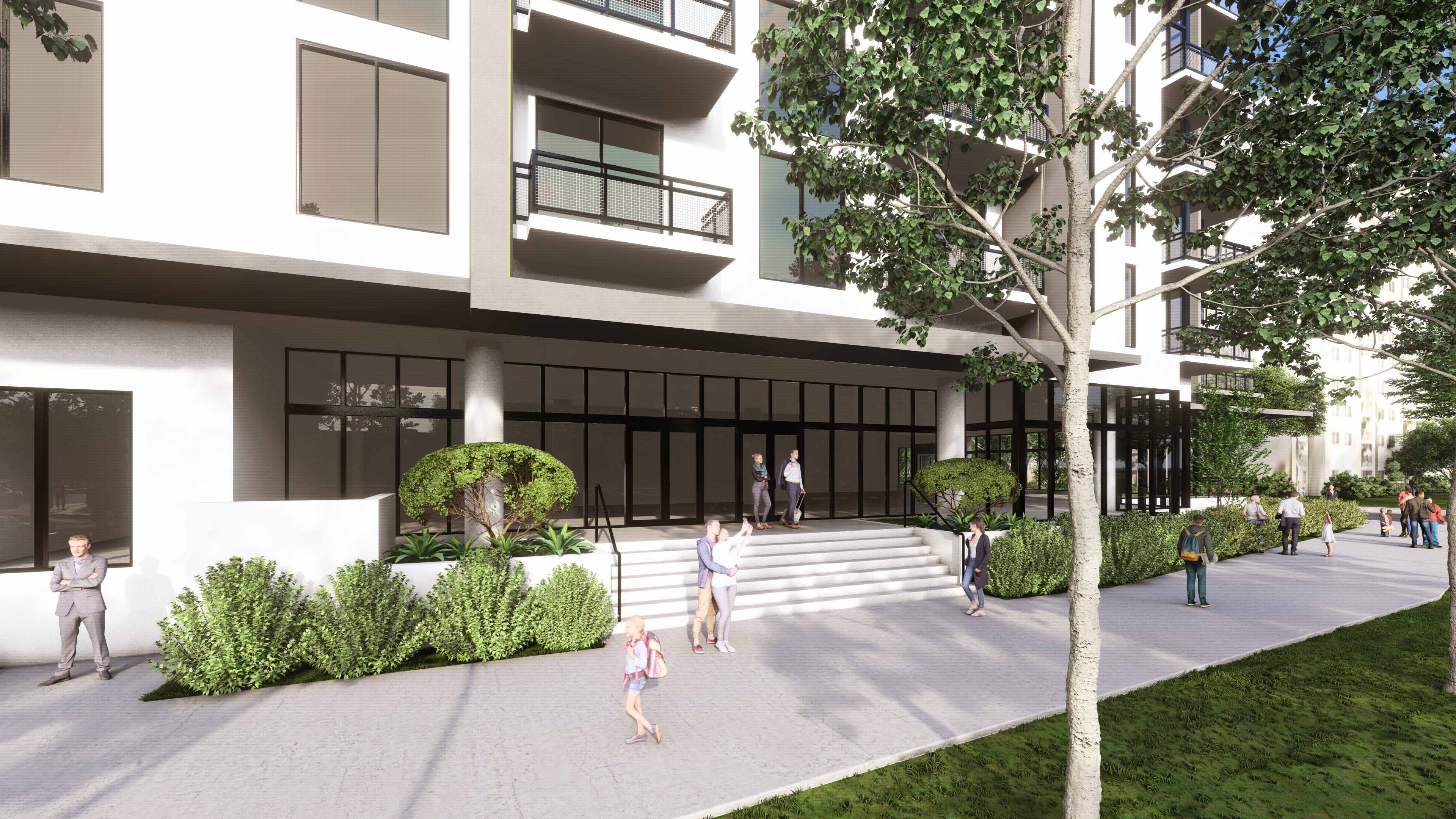 Front steps and glass entrance of River District 14 with trees and landscaping