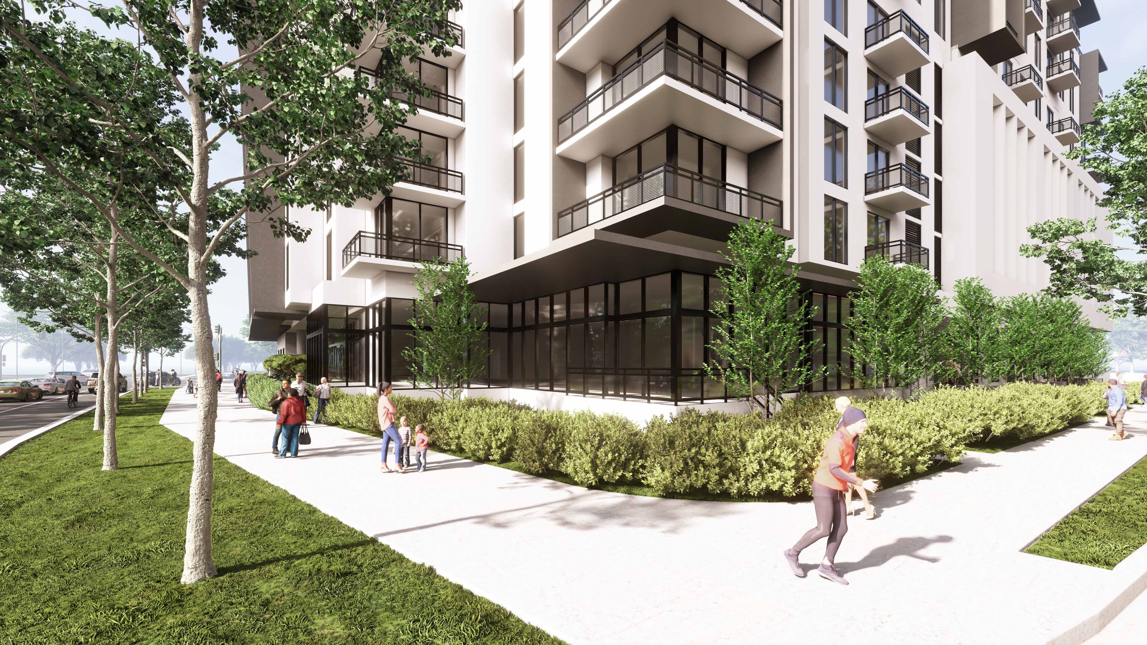 Ground-level corner view of River District 14 showing landscaped sidewalk and balconies