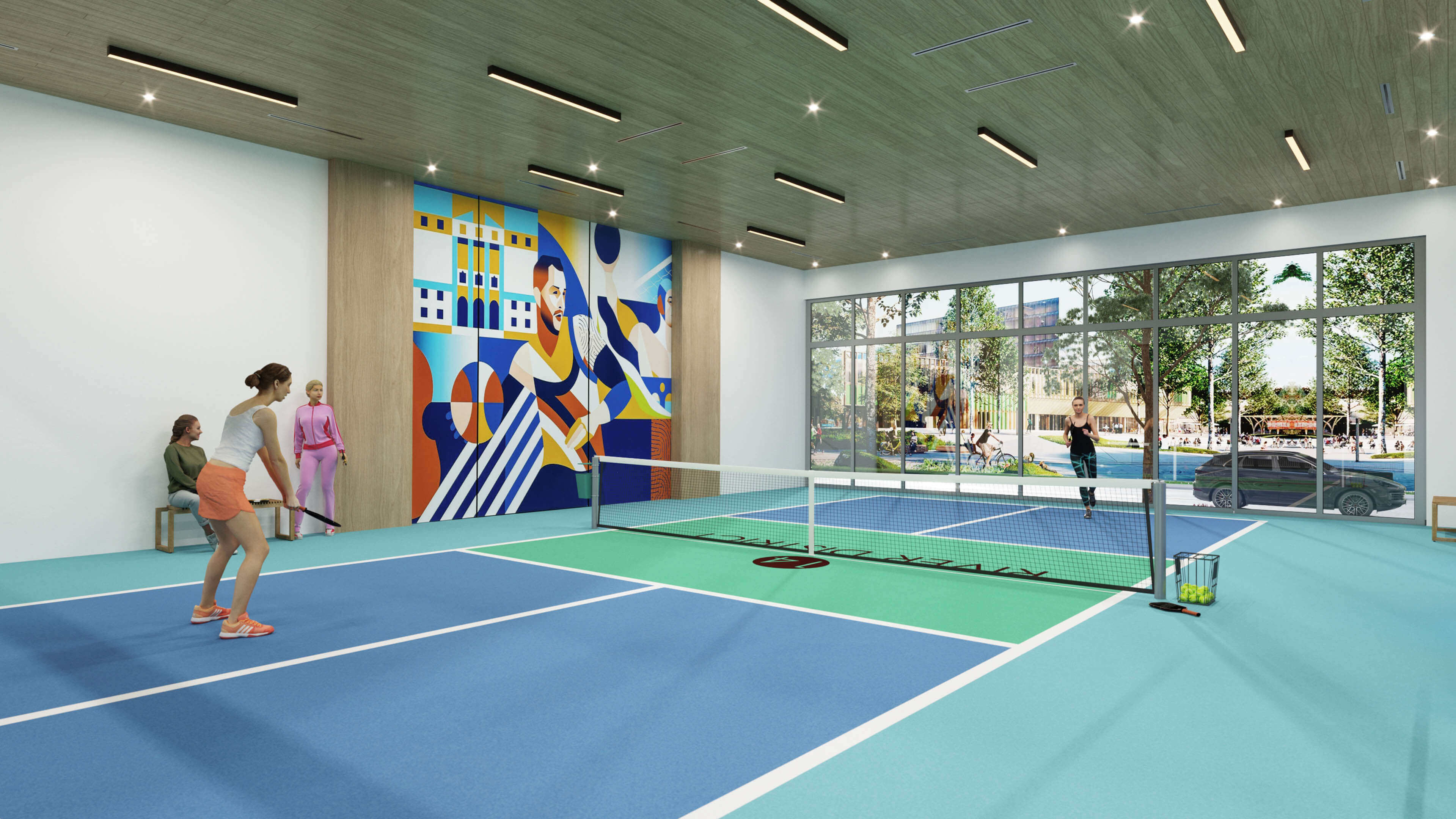 Indoor pickleball court with artistic mural at River District 14 amenities
