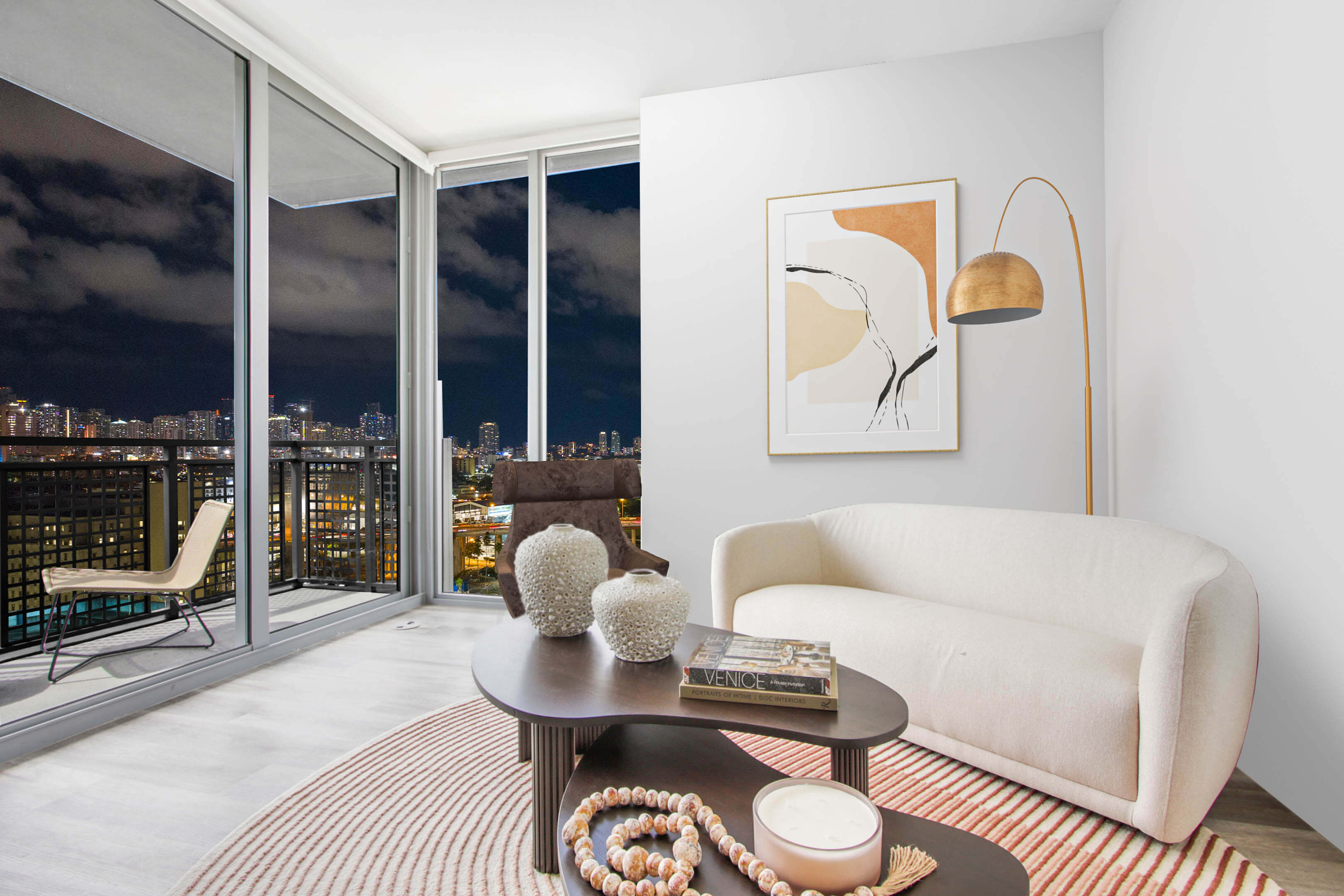Elegant living room at night with skyline and art decor at River District 14