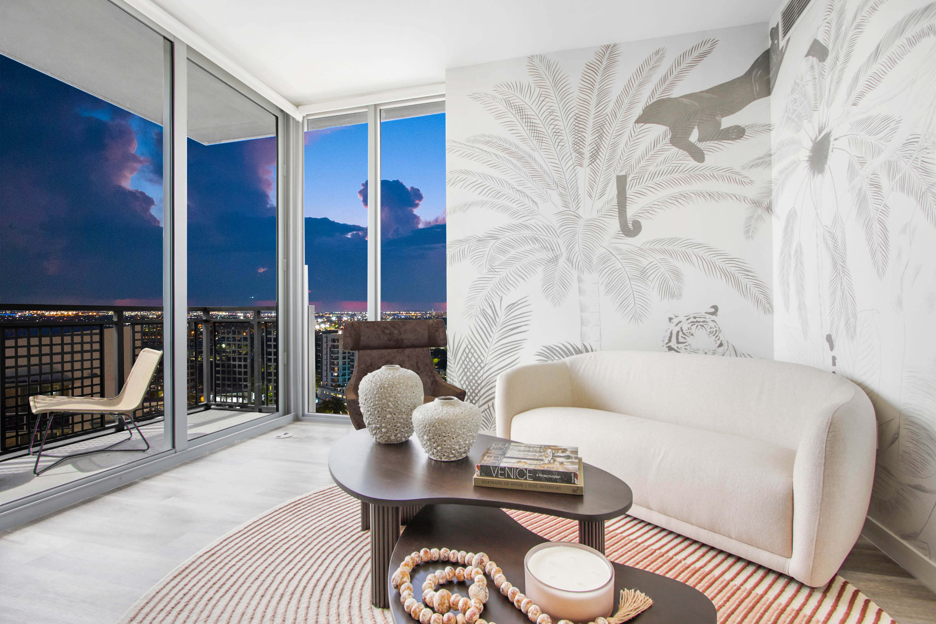 Living room with night cityscape view and artistic wallpaper at River District 14