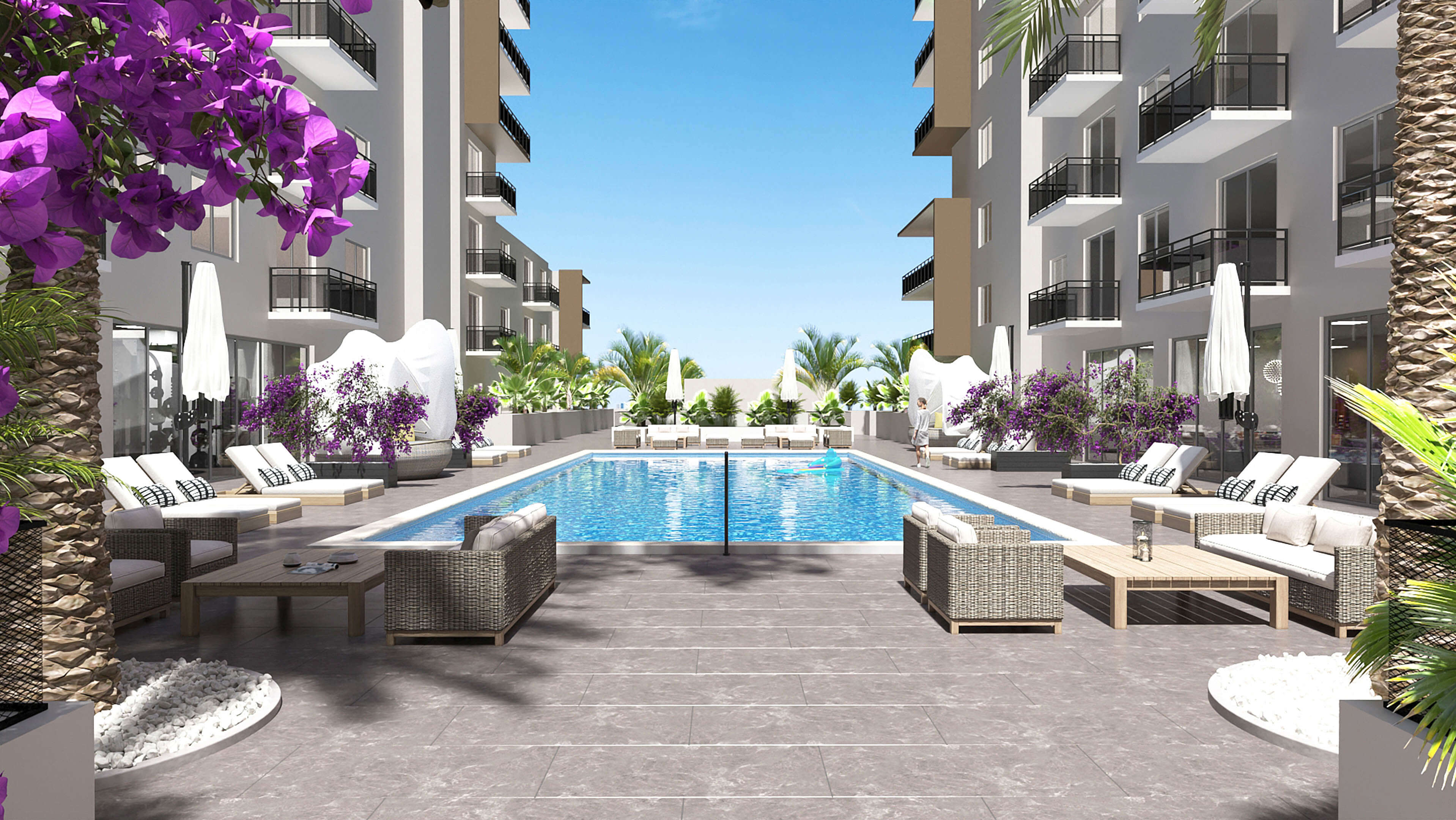 Poolside relaxation area with vibrant flowers at River District 14