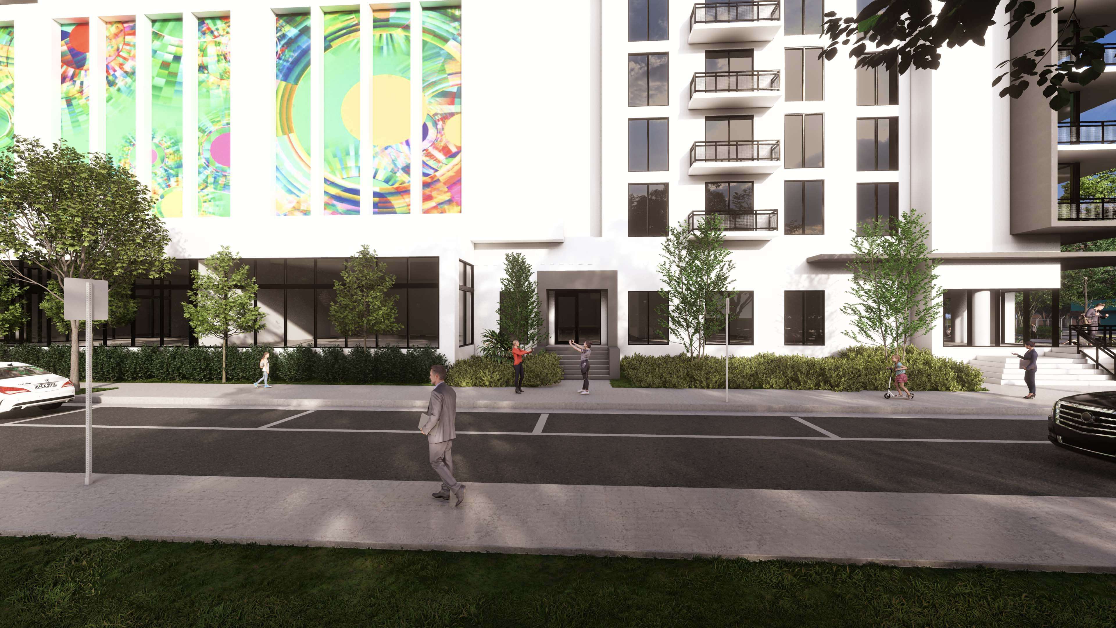 Sidewalk next to River District 14 with mural, trees and daily urban activity