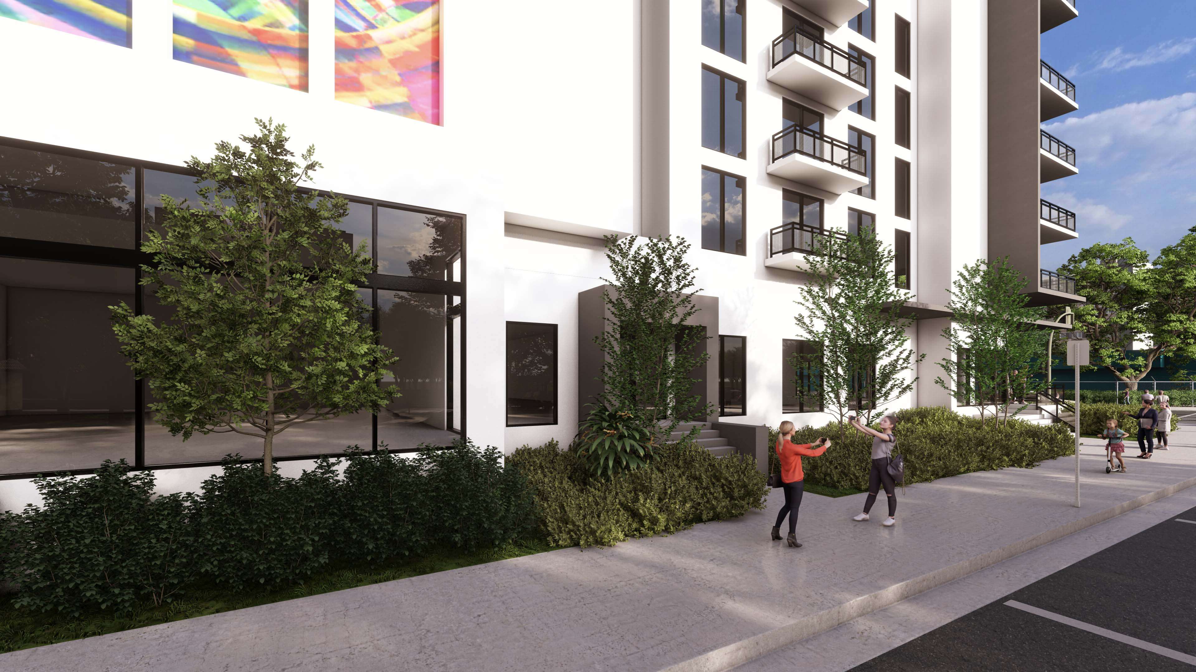 Corner street view of River District 14 showing balconies and people walking