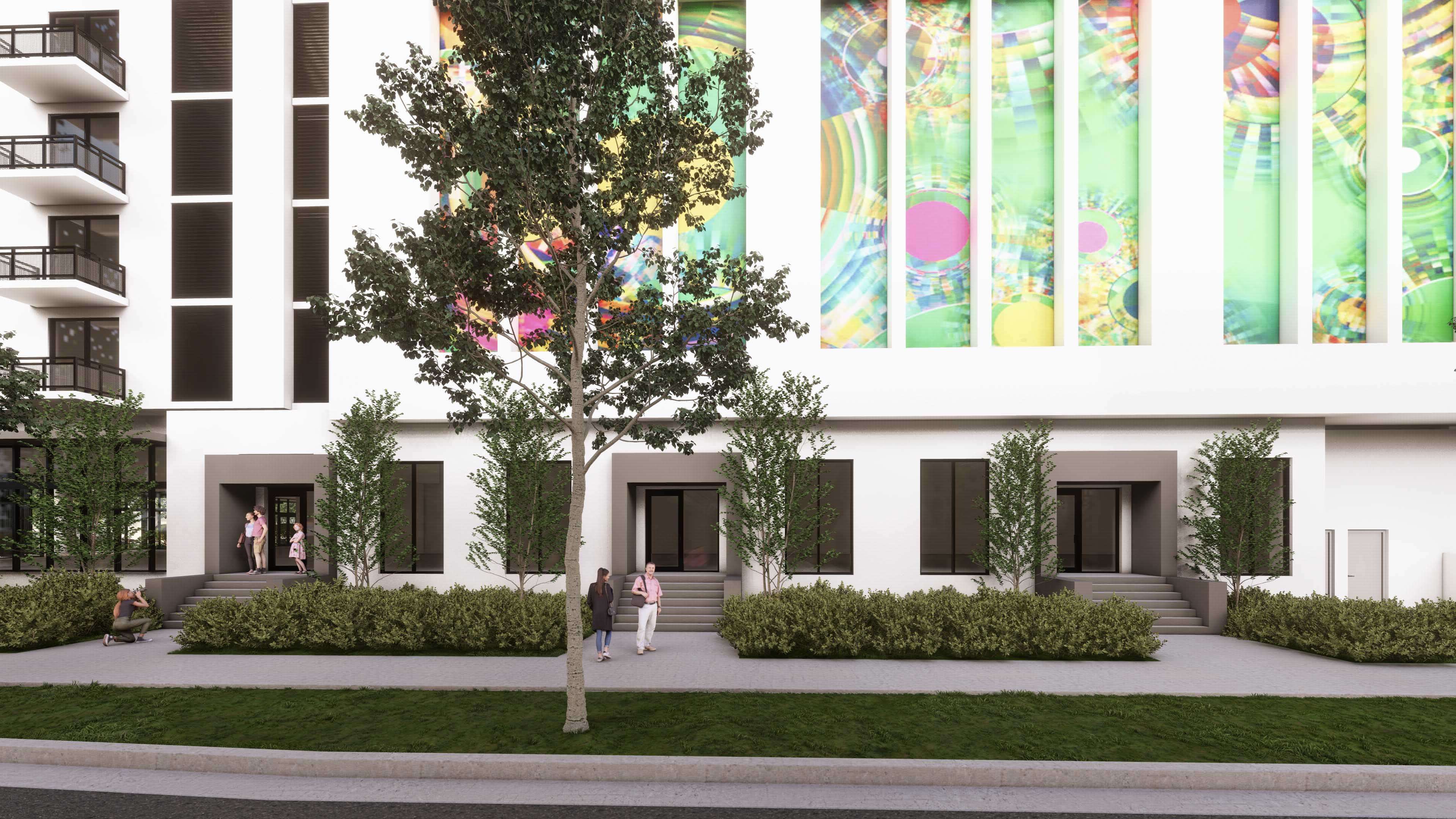 Street-level entry of River District 14 with vibrant mural and urban greenery