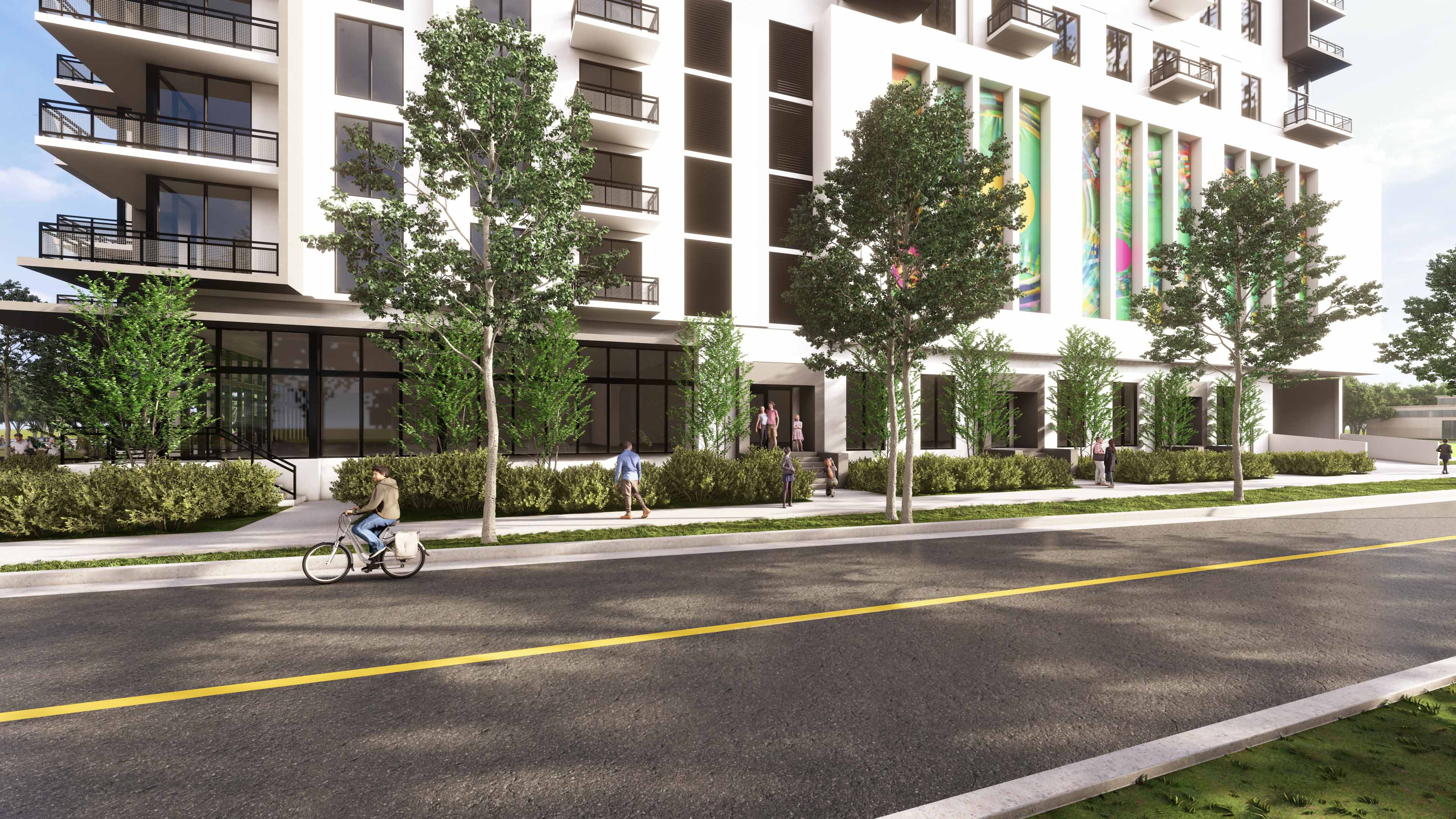 Streetfront of River District 14 with biking lane, greenery and building entrance