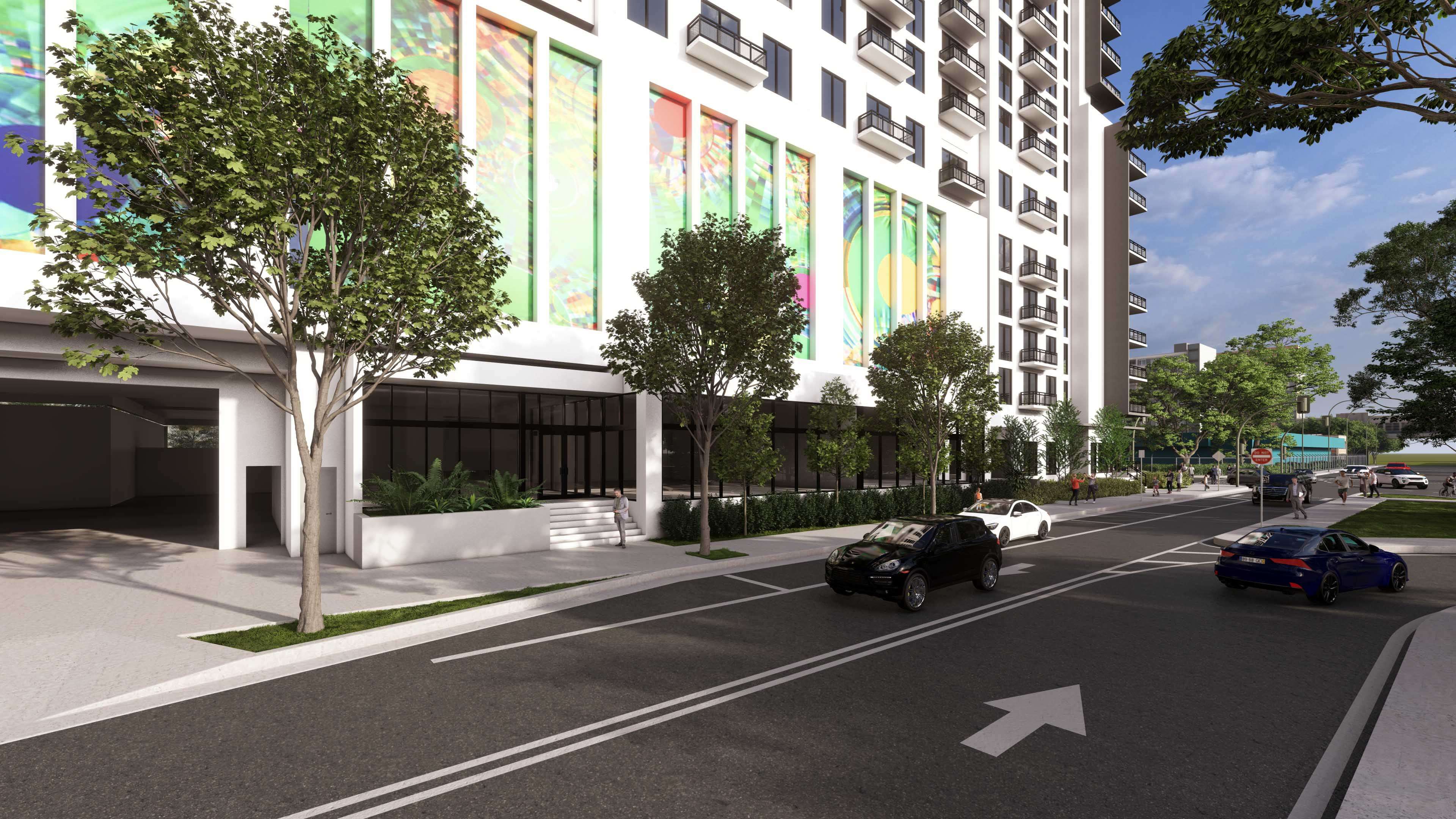 Urban side view of River District 14 with mural windows and tree-lined walkway