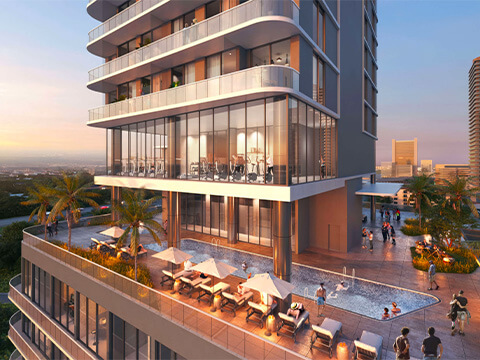 Amenity deck at Smart Brickell Luxe Tower III featuring a resort-style pool, lounge seating, and glass-enclosed fitness center