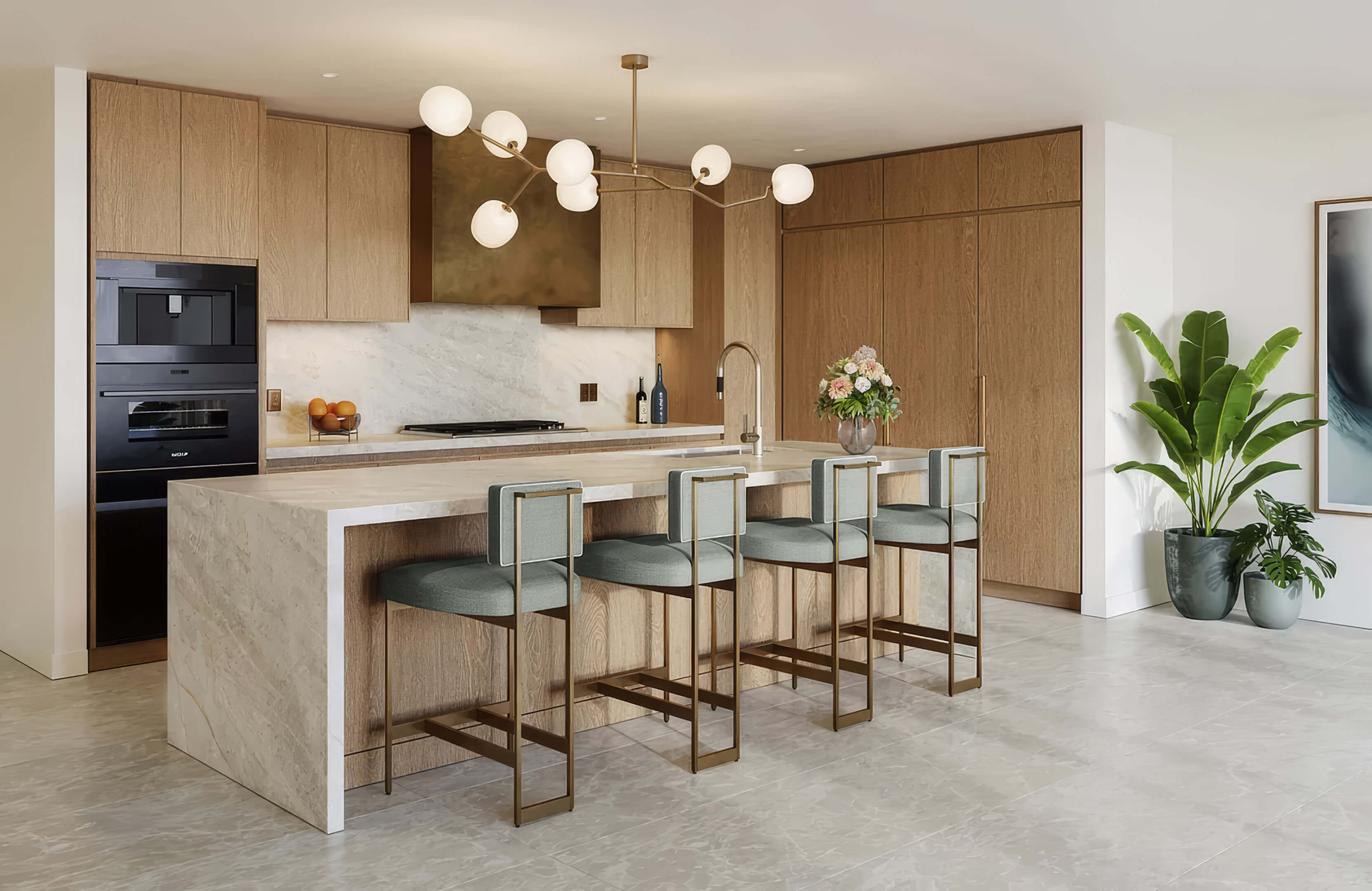 Kitchen with wood cabinetry, an island and four green bar stools at St Regis Residences Bahia Mar