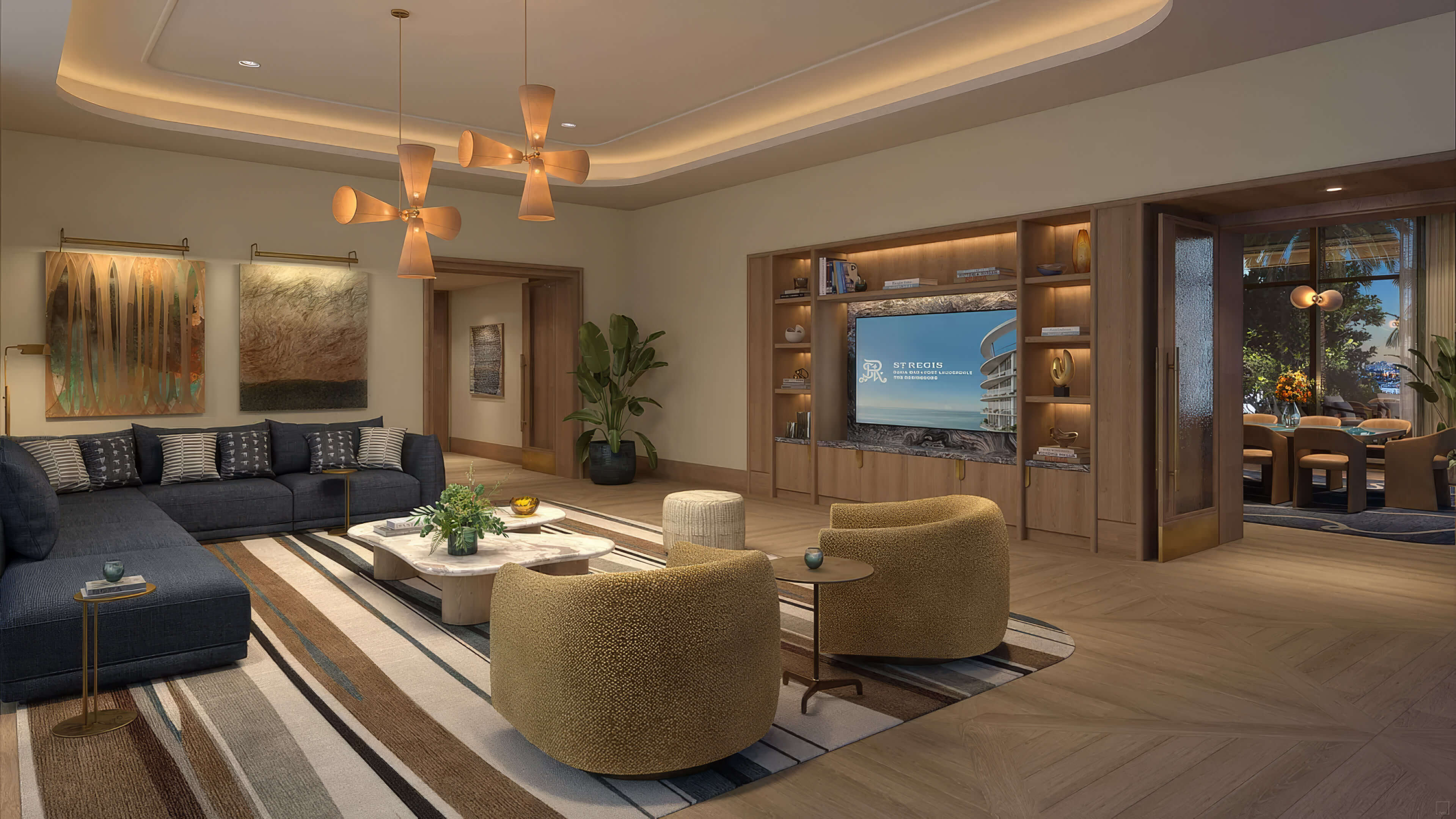Residents library with shelving, a television, dark sofas and rounded armchairs at St Regis Residences Bahia Mar