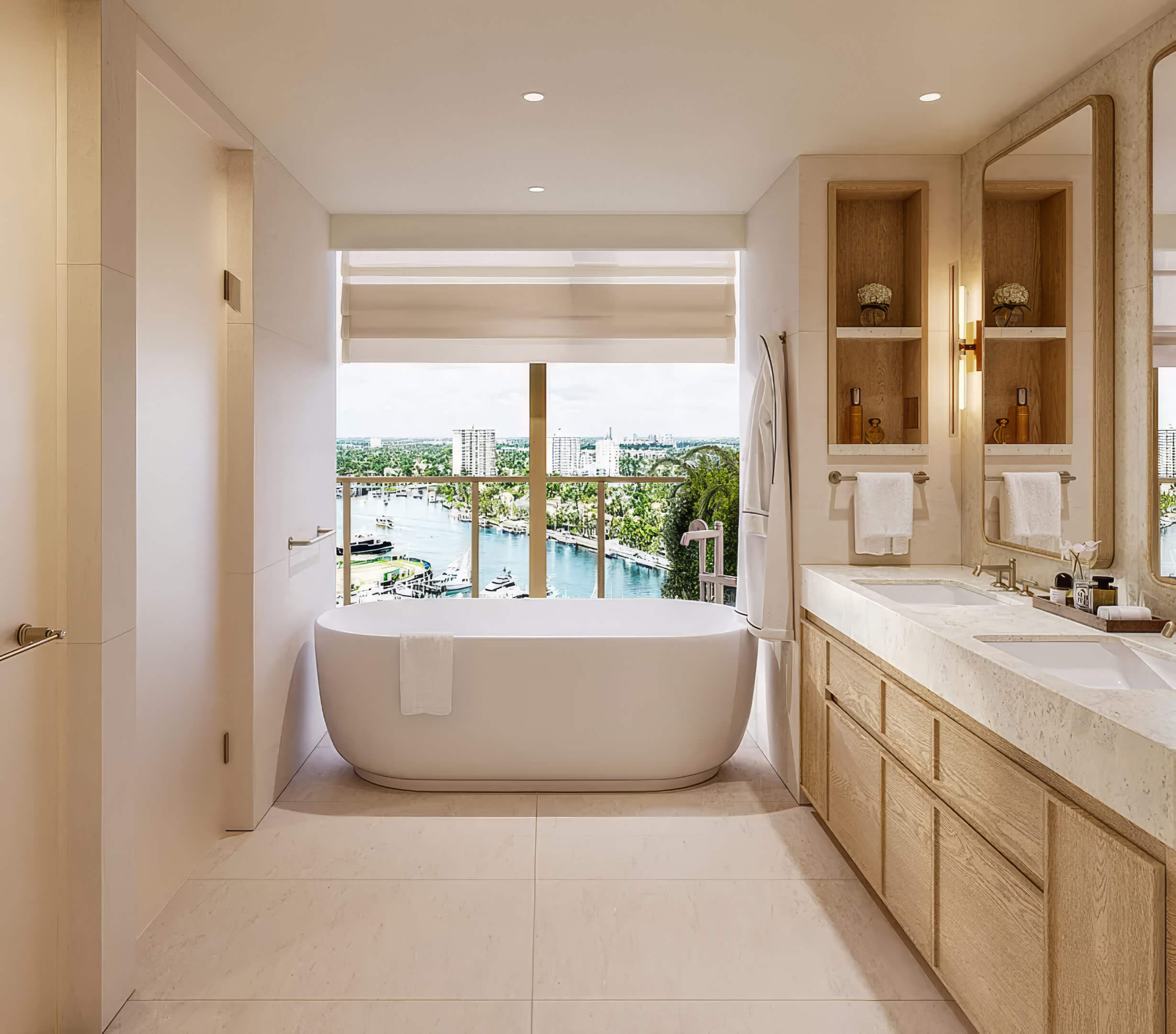 Bathroom with a freestanding tub by the window, a long vanity and water views at St Regis Residences Bahia Mar