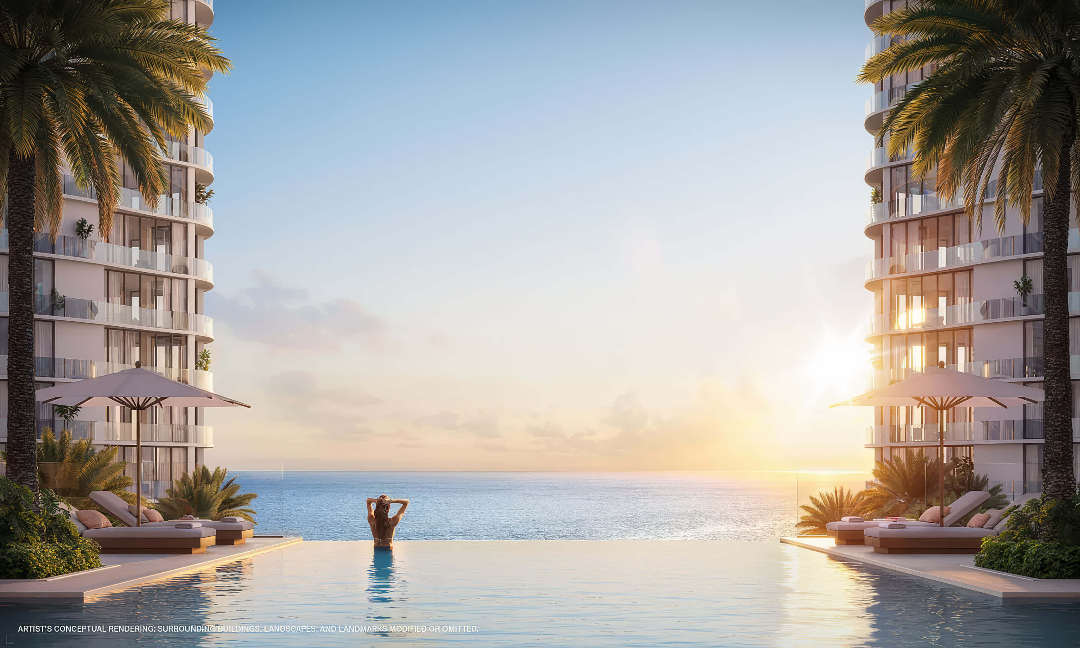 Infinity pool between curved towers with ocean views and low sunlight at St Regis Residences Bahia Mar