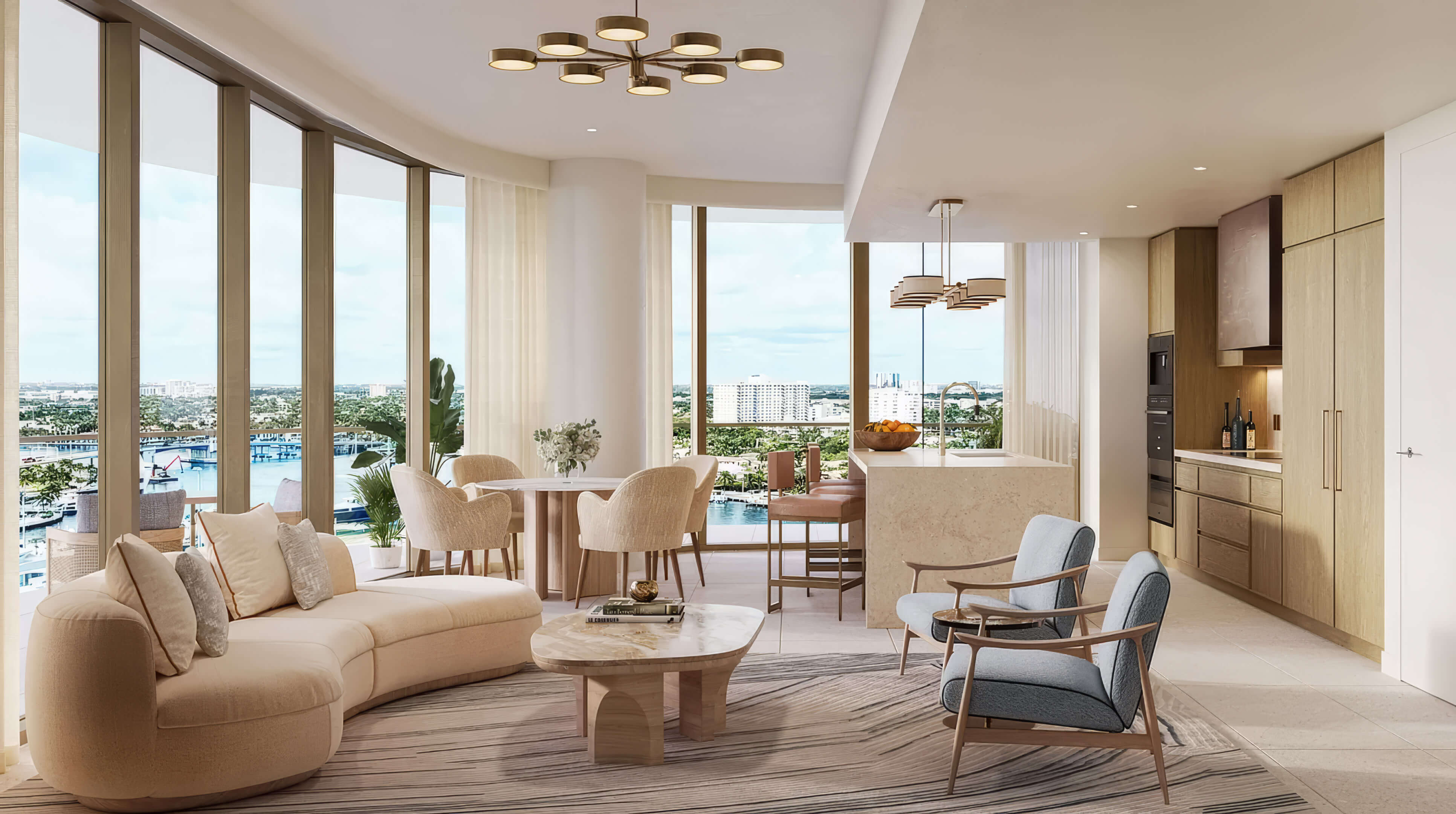 Open living and dining area with a kitchen island and water views at St Regis Residences Bahia Mar