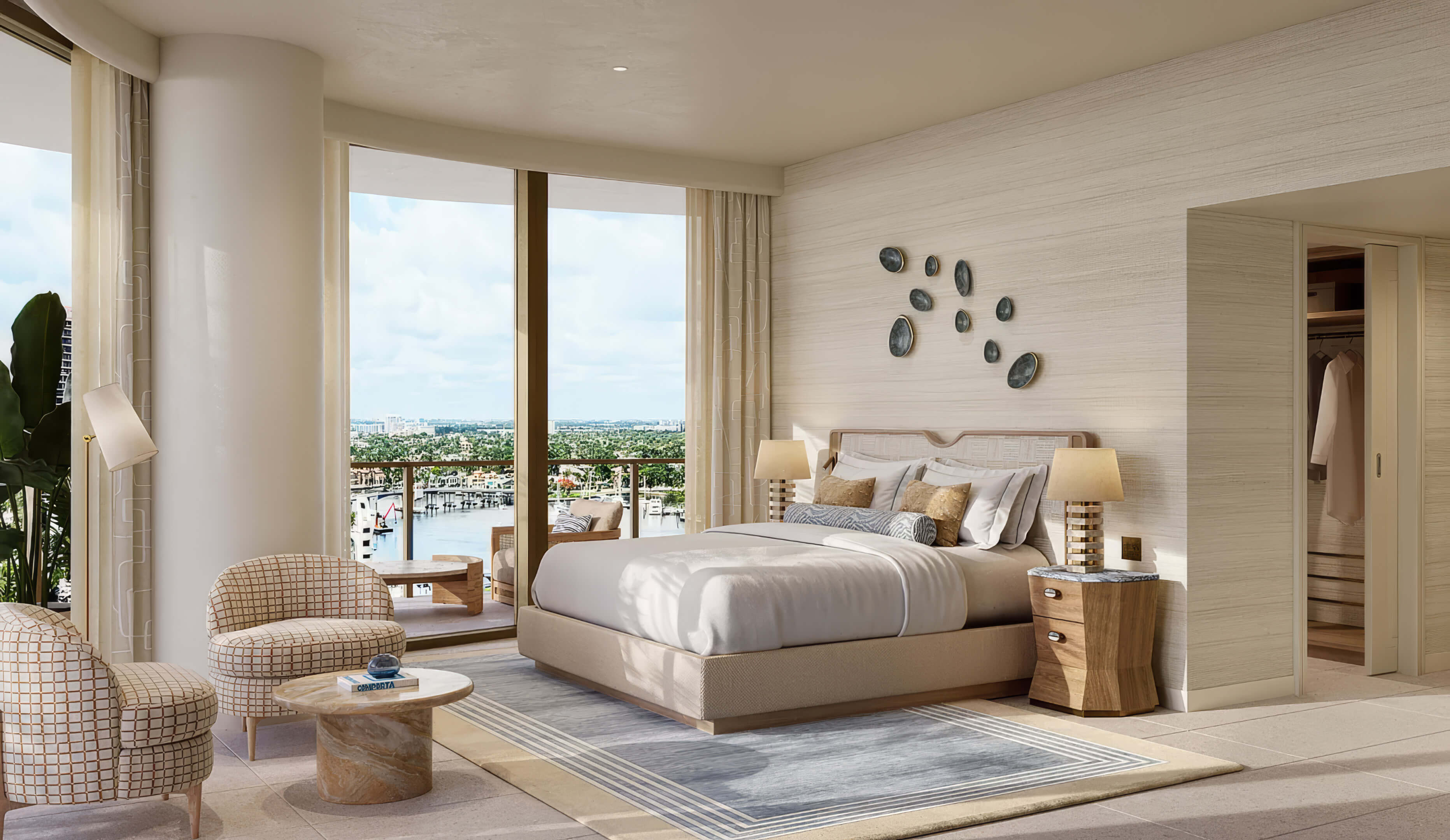 Bedroom with a waterfront view, lounge chairs and a walk-in closet at St Regis Residences Bahia Mar