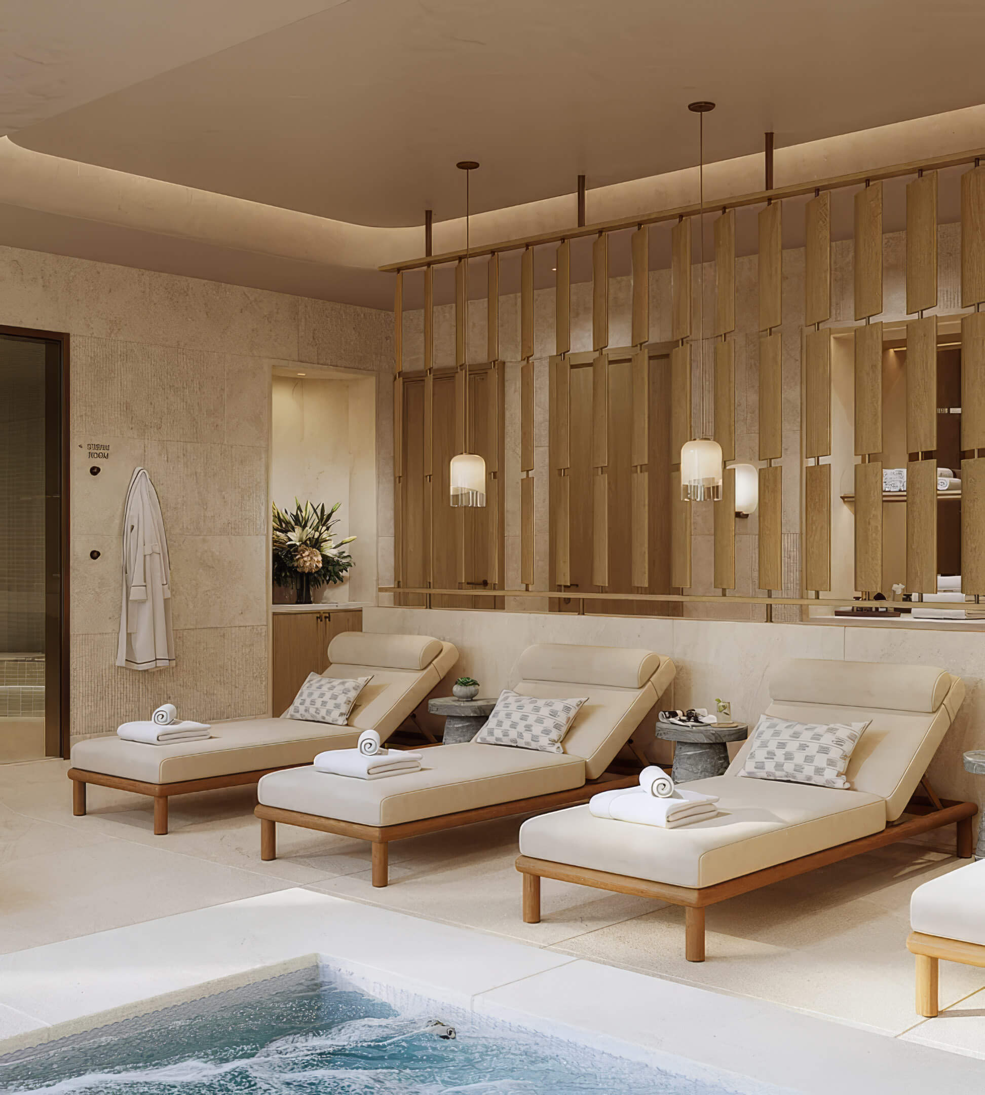 Spa relaxation room with cushioned loungers, towels and a pool edge at St Regis Residences Bahia Mar