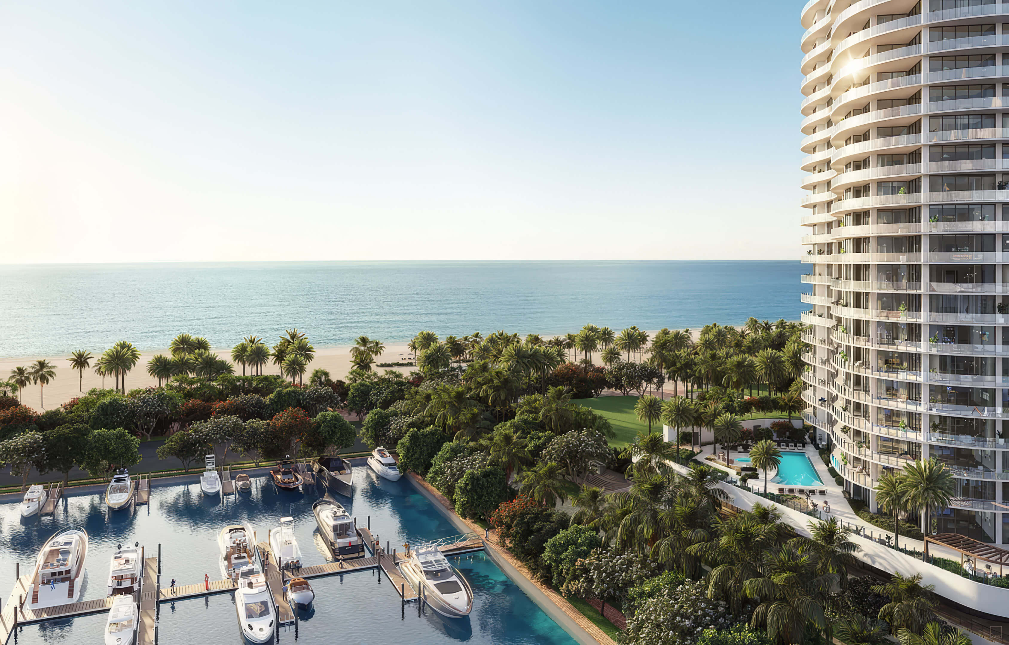 Curved tower balconies overlooking yachts, palms and the beach at St Regis Residences Bahia Mar