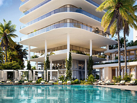 Poolside resort amenity at The Perigon Miami Beach with luxury cabanas, palm trees, and contemporary tower design