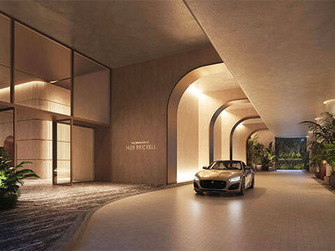 The Residences at 1428 Brickell Miami private arrival driveway with elegant arches, luxury car and tropical landscaping