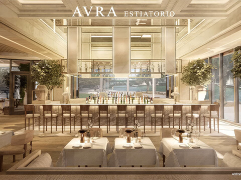 Avra main bar at The Standard Residences Brickell with a central counter, bar stools, and tall trees