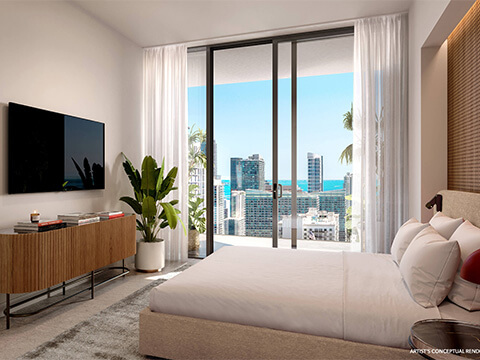 The Standard Residences Brickell bedroom with a padded headboard, wall mounted television, and city view