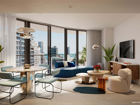 The Standard Residences Brickell living and dining room with a curved blue sofa and corner windows