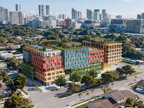 Aerial view of WOMA Wynwood in Miami surrounded by residential neighborhoods and the city skyline