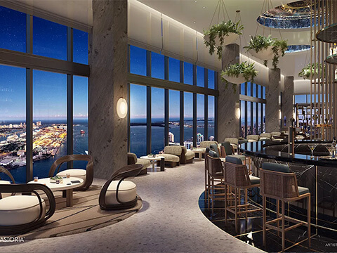 Waldorf Astoria Residences luxury cocktail bar with floor-to-ceiling windows and panoramic Miami bay views at night