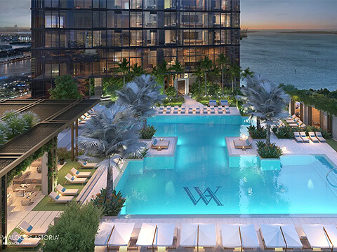 Waldorf Astoria Residences rooftop pool deck with cabanas, palm trees and panoramic waterfront views