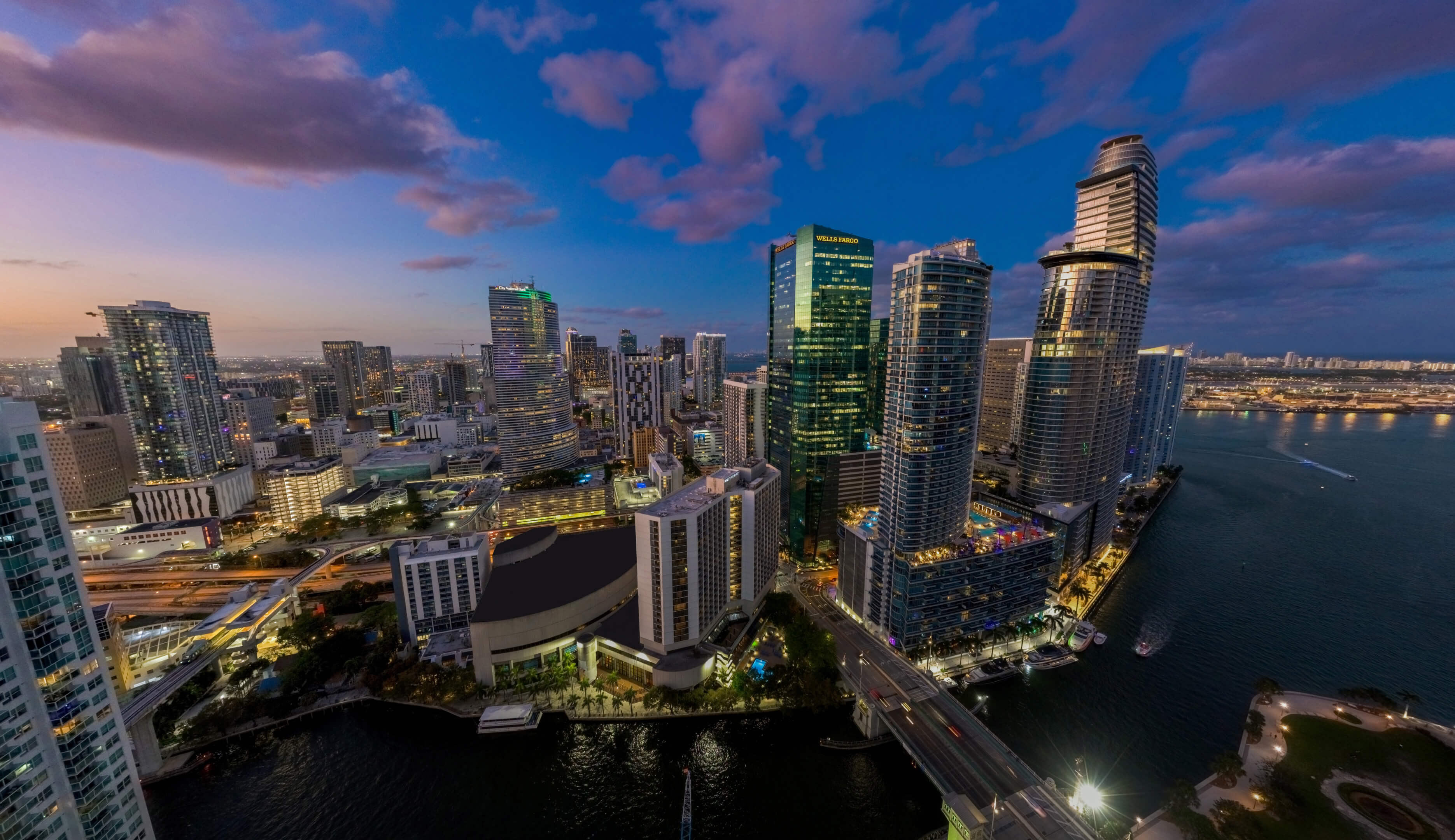 Night aerial view of Viceroy Brickell and Miami skyline with bayfront lights and skyscrapers