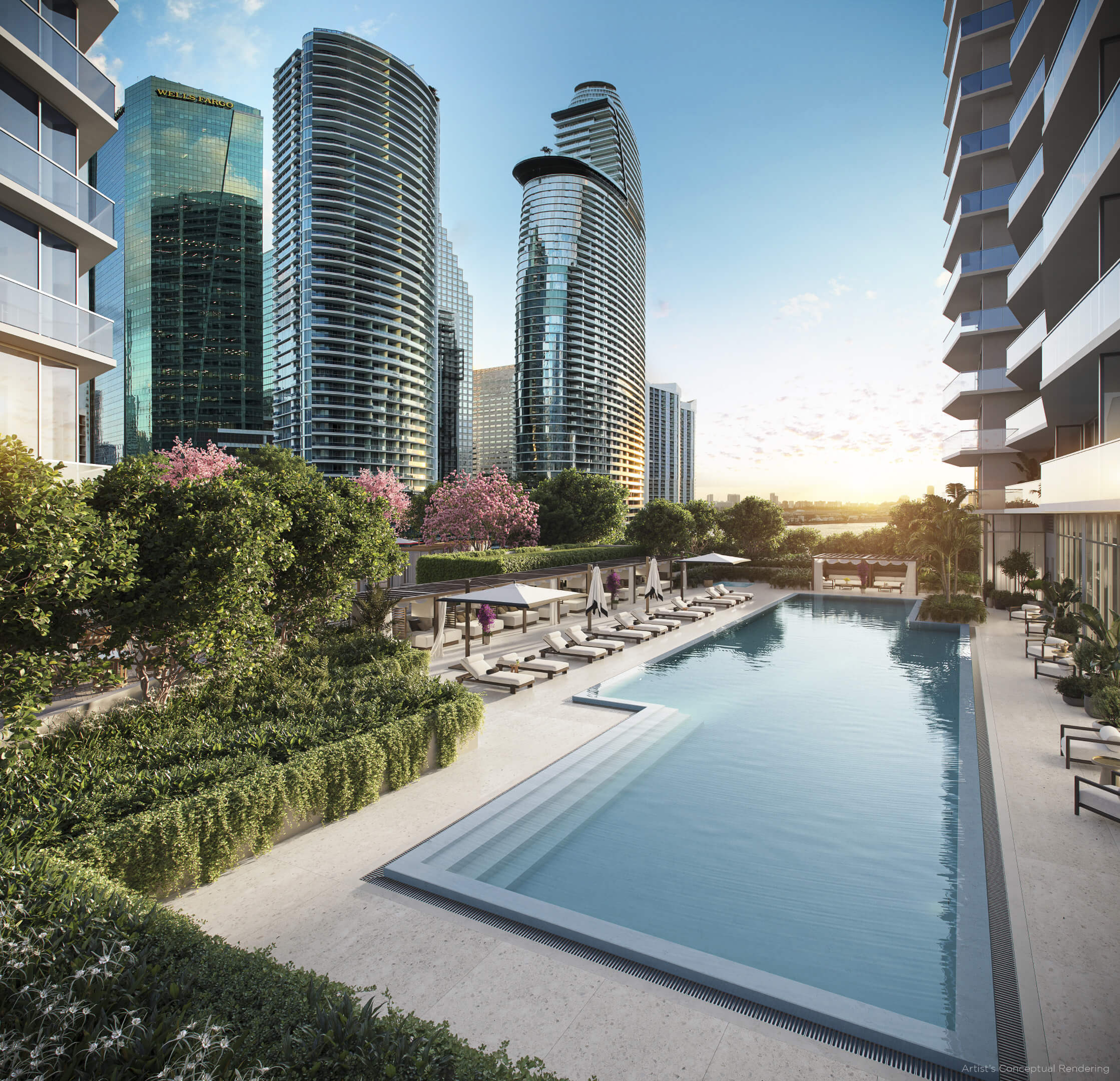 Multiple resort-style pools at Viceroy Brickell Residences with lush gardens and marina view